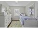 Bright bedroom featuring hardwood floors, three windows, and white furniture at 1504 Forrest Ave, Folly Beach, SC 29439