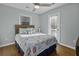 Serene bedroom featuring a queen bed with nautical-themed bedding, a ceiling fan, and lots of sunlight at 1504 Forrest Ave, Folly Beach, SC 29439