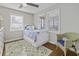Cozy bedroom with hardwood floors, three windows, and a comfortable bed at 1504 Forrest Ave, Folly Beach, SC 29439