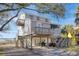 Beautiful coastal home with multiple decks, landscaped yard, and charming architectural details at 1504 Forrest Ave, Folly Beach, SC 29439
