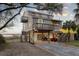 Charming stilted home features a spacious outdoor area, boardwalk access, and serene marsh views at 1504 Forrest Ave, Folly Beach, SC 29439