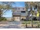 Charming coastal home with elevated design, well-maintained landscaping, and a scenic waterfront backdrop at 1504 Forrest Ave, Folly Beach, SC 29439