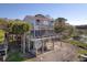 Stunning elevated beach home features a large deck, screened porch, and outdoor entertainment space at 1504 Forrest Ave, Folly Beach, SC 29439