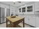 Well-lit kitchen with stainless steel appliances and white cabinets, plenty of counter space at 1504 Forrest Ave, Folly Beach, SC 29439