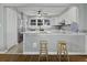 Open kitchen with island, marble countertops, stainless appliances, and bar stool seating at 1504 Forrest Ave, Folly Beach, SC 29439
