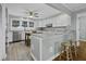 Open kitchen with stainless steel appliances, wood floors, and a center island at 1504 Forrest Ave, Folly Beach, SC 29439