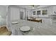 Bright kitchen with marble countertops, stainless steel appliances, and an island with bar seating at 1504 Forrest Ave, Folly Beach, SC 29439