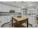 Modern kitchen with white cabinets, stainless appliances, and a wooden island at 1504 Forrest Ave, Folly Beach, SC 29439