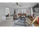 Inviting living room with stylish furnishings and a cozy sectional sofa with a ceiling fan at 1504 Forrest Ave, Folly Beach, SC 29439