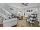 Comfortable living room with two sofas, a staircase and an open view to the kitchen at 1504 Forrest Ave, Folly Beach, SC 29439