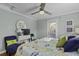 Airy main bedroom featuring light blue walls, a ceiling fan, and patio access at 1504 Forrest Ave, Folly Beach, SC 29439