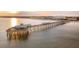 Capture of the pier at sunset, highlighting the pier's attractions including shops, eateries, and people at 1504 Forrest Ave, Folly Beach, SC 29439