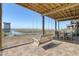 Inviting outdoor porch with a swing and dining area, perfect for relaxing and enjoying the view at 1504 Forrest Ave, Folly Beach, SC 29439