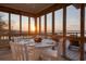 Enjoy marsh views from this screened porch, perfect for dining or relaxing with tranquil scenery at 1504 Forrest Ave, Folly Beach, SC 29439