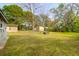 Spacious backyard featuring lush green grass and mature trees, ideal for outdoor enjoyment at 1617 Balsam St, Charleston, SC 29407