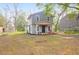 Charming two-story home featuring a quaint front porch, landscaped yard, and mature trees at 1617 Balsam St, Charleston, SC 29407