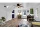 Well-lit living room with hardwood floors leading to a vibrant blue kitchen at 1617 Balsam St, Charleston, SC 29407