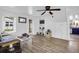 Bright living room with hardwood floors, built-in shelving, and a ceiling fan at 1617 Balsam St, Charleston, SC 29407