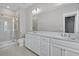 Bright bathroom boasting double sinks, spacious vanity, large mirror, and a tiled walk-in shower at 1675 Indy Dr, North Charleston, SC 29405