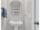Compact bathroom featuring pedestal sink, modern fixtures, and neutral color scheme at 1675 Indy Dr, North Charleston, SC 29405