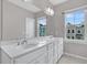 Bathroom featuring double sinks, a large mirror, bright window and ample natural light at 1675 Indy Dr, North Charleston, SC 29405