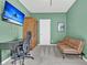 Stylish home office featuring modern furniture, a large armoire, and a mounted television at 1675 Indy Dr, North Charleston, SC 29405