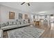 Open-concept living room with modern furnishings, flowing into a bright kitchen and dining area at 1675 Indy Dr, North Charleston, SC 29405