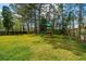Fenced backyard featuring a wooden playset with swing set and mature trees at 184 Ponderosa Dr, Ladson, SC 29456