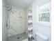 Bathroom with marble tile shower, hexagon tile floor, toilet, and bright window at 184 Ponderosa Dr, Ladson, SC 29456