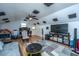 Large bonus room with wood floors, ceiling fan, media center, and plenty of space for entertaining at 184 Ponderosa Dr, Ladson, SC 29456