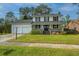 Charming two-story home featuring a welcoming front porch and well-maintained lawn with a two car garage at 184 Ponderosa Dr, Ladson, SC 29456