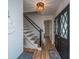 Bright foyer featuring a modern staircase, hardwood floors, and a stylish door with a decorative glass insert at 184 Ponderosa Dr, Ladson, SC 29456
