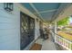 Inviting front porch featuring rocking chairs, stylish lighting, and attractive double doors with leaded glass insets at 184 Ponderosa Dr, Ladson, SC 29456