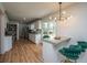 Bright, open kitchen with white cabinetry, granite counters, stainless appliances, and stylish barstool seating at 184 Ponderosa Dr, Ladson, SC 29456