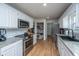 Updated kitchen features stainless appliances, granite counters, a pantry, and light-colored wood floors at 184 Ponderosa Dr, Ladson, SC 29456