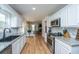 Updated kitchen with stainless appliances, granite counters, white cabinets, and light-colored wood floors at 184 Ponderosa Dr, Ladson, SC 29456