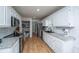 Bright kitchen features stainless appliances, granite counters, a pantry, and wood floors at 184 Ponderosa Dr, Ladson, SC 29456
