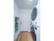 Modern laundry area featuring stacked washer and dryer and an exterior door at 184 Ponderosa Dr, Ladson, SC 29456