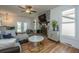 Inviting living room featuring a stone fireplace, hardwood floors, and lots of windows for ample natural light at 184 Ponderosa Dr, Ladson, SC 29456