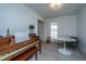 Bright living room with hardwood floors, piano, and white marble tulip table and room for seating at 184 Ponderosa Dr, Ladson, SC 29456