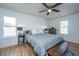 Bright bedroom with ceiling fan, two windows for natural light, and wood-look flooring at 184 Ponderosa Dr, Ladson, SC 29456