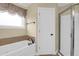 Bathroom featuring a bathtub, a walk-in shower with a glass door and neutral color at 2107 Military Way, Charleston, SC 29414