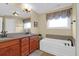 Primary bathroom with double vanity, a large bathtub, and neutral walls at 2107 Military Way, Charleston, SC 29414