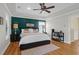 Bright bedroom with tray ceilings, dark accent wall, and ceiling fan at 2107 Military Way, Charleston, SC 29414