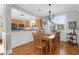 Bright dining room with hardwood floors, chandelier, and adjacent kitchen access at 2107 Military Way, Charleston, SC 29414
