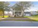 Charming two-story home boasts a large front porch and a detached garage with a basketball hoop at 2107 Military Way, Charleston, SC 29414