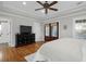 Main bedroom with a tray ceiling, hardwood floors, and double doors to an outdoor balcony at 2107 Military Way, Charleston, SC 29414