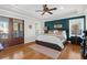 Stylish primary bedroom featuring hardwood floors, tray ceilings, and a private outdoor balcony at 2107 Military Way, Charleston, SC 29414