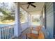 Inviting front porch featuring wood flooring, ceiling fan, and comfortable seating area to relax at 2107 Military Way, Charleston, SC 29414