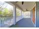 Spacious second story porch offering ample outdoor space with neutral flooring and ceiling fan at 2107 Military Way, Charleston, SC 29414